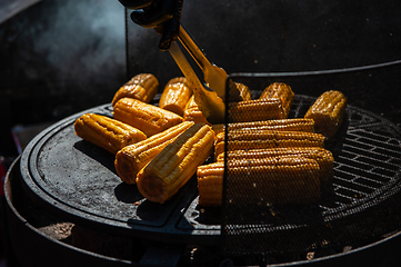 Image showing A professional cook prepares corn