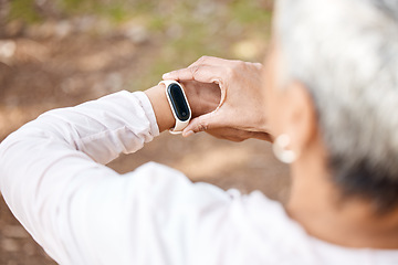 Image showing Senior woman, check smart watch and fitness in park to monitor speed, heart or progress. Outdoor, female runner and iot clock for time, training or exercise with stopwatch, nature or summer sunshine