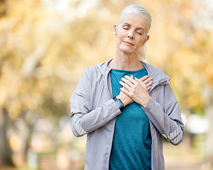 Image showing Fitness, heart attack and senior woman on a run for race, marathon or sports training in a park. Nature, health and elderly female person with a chest condition while doing cardio workout or exercise