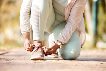 Image showing Fitness, feet and person tying laces for exercise, workout and outdoor training ready for wellness and health. Sneakers, shoes and woman or runner prepare footwear for running, sports and marathon