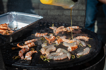 Image showing A professional cook prepares shrimps