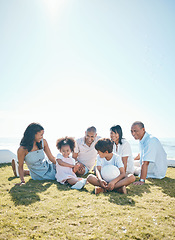 Image showing Parent, children and generations are relaxing on grass in summer for quality time on holiday in mockup space. Happiness, kid and big family in outdoor for bond at resort with ball at house or ocean.