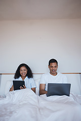 Image showing Technology, relax and couple in bed networking on social media or the internet together at home. Happy, smile and young man and woman browsing on a digital tablet and laptop in bedroom in the morning