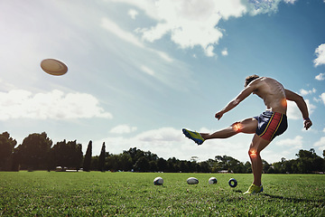 Image showing Man, field and kick rugby ball for sport with red glow, knee and injury on grass with pain for fitness. Athlete guy, overlay for joint pain, power and workout for contest, competition and development