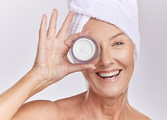 Image showing Portrait, cream and beauty with old woman, happy with skincare and dermatology on white background. Sunscreen, moisturizer and face care, female model apply lotion with glass container and skin