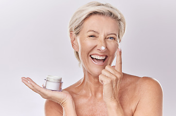 Image showing Portrait, cream and beauty with senior woman, happy with skincare and dermatology on white background. Sunscreen, moisturizer and face care, female model apply lotion with glass container and skin