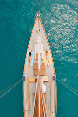 Image showing Aerial, ocean and women with phone on boat relax for cruise, luxury sailing and transport on sea. Social media, travel and female people on yacht for tropical journey, sunbathing and tourism on water