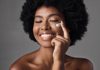 Image showing African woman, skincare cream or smile in studio with afro, face and cosmetics for smile by background. Girl, model and happy for natural self care with health, eyes closed and lotion for beauty