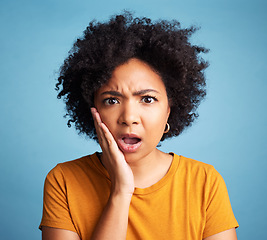 Image showing Confused, surprise or portrait of black woman with hand on face in shock, doubt or omg expression for announcement on studio background. Emoji, person and shocked reaction for news, story or gossip