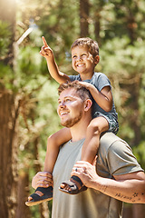 Image showing Hiking, family and a boy pointing with his dad while sitting on his shoulders outdoor in the forest or woods. Kids, love or adventure with a son and his father in the wilderness to explore nature