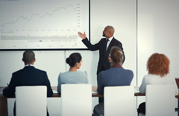 Image showing Presentation, black man in a business meeting and training in an office of their workplace. Leader or strategy, collaboration or teamwork and people in a workshop for statistics or planning.