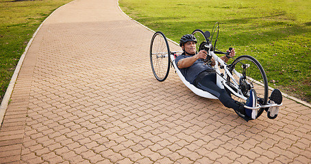 Image showing Cycling, disability and challenge with man and bike with handicap for training, sports and fitness. Exercise, workout and wheelchair with disabled person training in park for cardio and health