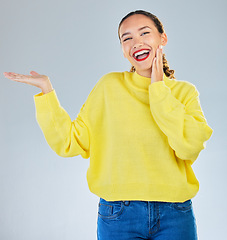Image showing Space, smile and presentation with portrait of woman in studio for show, advertising and idea. Announcement, promotion and deal with person on grey background for opportunity, offer and news