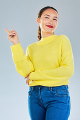 Image showing Pointing, smile and presentation with portrait of woman in studio for show, advertising and idea. Announcement, promotion and deal with person on grey background for opportunity, offer or news mockup