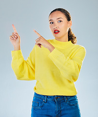 Image showing Pointing, shock and presentation with portrait of woman in studio for show, advertising and idea. Announcement, wow and deal with person on grey background for opportunity, offer and news mockup