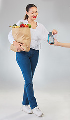 Image showing Card machine, grocery shopping and woman for business, POS and shop payment, fintech or digital finance. Groceries, credit and cashier hands, people and food bag at point of sale on studio background