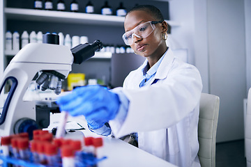 Image showing Blood test, microscope and science woman in laboratory for cancer research, medical analysis and dna test. Biotechnology, red liquid and scientist, doctor or african person, check tube in healthcare