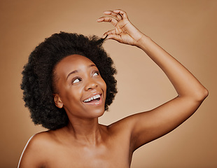 Image showing Happy black woman, hair care and natural afro for beauty in studio isolated on a brown background. Growth, hairstyle or excited African model with cosmetics after salon treatment for healthy wellness