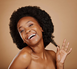 Image showing Portrait, smile and black woman pulling hair, growth and wellness against a brown studio background. Face, female person and happy model with beauty, luxury and volume with fun, playful and cosmetics