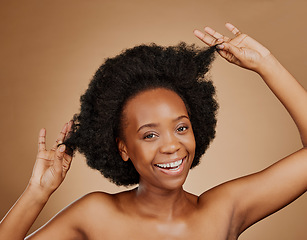 Image showing Portrait, beauty and black woman pulling hair, cosmetics and wellness against a brown studio background. Face, female person and model with luxury, playful and volume with fun, texture and shampoo