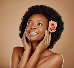 Image showing Skincare, flower and young woman in studio with beauty, natural and wellness face routine. Cosmetic, health and African female model with floral rose in hair for facial treatment by brown background.