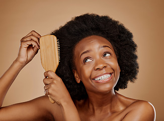 Image showing Black woman, hairstyle and smile for brush in studio, brown background and treatment for curly texture. Natural beauty, confidence and happy young african female model comb clean or healthy afro hair