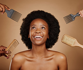 Image showing Hair, comb and brush selection with a black woman in studio on a brown background for beauty or cosmetics. Salon, afro or haircare with hands at a hairdresser and an attractive young female model