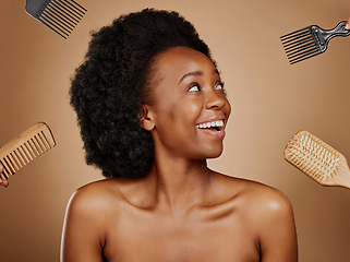 Image showing Hair, comb and brush options with a black woman in studio on a brown background for beauty or cosmetics. Hairdresser, afro or haircare with hands at a style salon and an attractive young female model