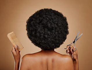 Image showing Back, comb and scissors with a black woman in studio on a brown background for a haircut. Salon, afro and haircare with a natural female model at the hairdresser for hairstyling or beauty from behind