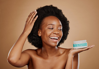 Image showing Beauty, thinking and a black woman with a product for hair care, wellness and shine. Smile, glow and an African girl or model with a vision for afro cosmetics in a container on a studio background