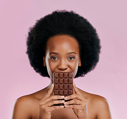 Image showing Portrait, chocolate and black woman with snack, natural beauty and sugar treat on a studio background. Face, female person or Jamaican model with sweets, cocoa candy and delicious snack with calories