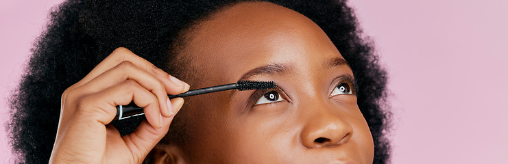 Image showing Eyes, mascara and brush, makeup and black woman, beauty and cosmetic product on pink background. Female model, hand and eyelash extension, cosmetology and lashes transformation with glow in studio