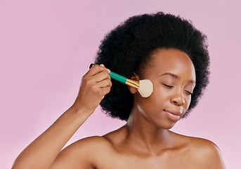 Image showing Black woman, brush and makeup with beauty and skin, foundation or powder application on pink background. Cosmetic tools, skincare and African model glow, cosmetology and facial, self care in studio