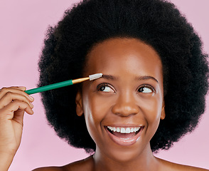 Image showing Makeup, face and black woman with mascara, excited and beauty in studio isolated on a pink background. Brush, eyebrow cosmetics and happy African model apply facial treatment, wellness or aesthetic.