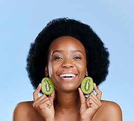 Image showing Skincare portrait, kiwi and woman for beauty, cosmetics and natural product, healthy glow and vitamin c promotion. Face of African person or model, fruits and dermatology on a studio, blue background