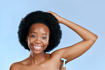 Image showing Smile, portrait or black woman woman shaving armpit with a razor blade for hair removal, hygiene or wellness. Studio, blue background or happy girl model grooming underarms for healthy clean skincare