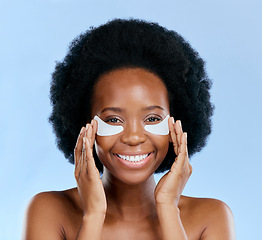 Image showing Beauty, skincare and eye mask with portrait of black woman in studio for facial, cosmetics or dermatology. Spa, wellness and self care with face of person on blue background for salon, glow and detox