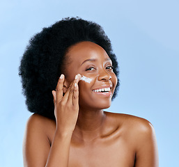 Image showing Black woman, face and cream, beauty and cosmetic care with smile and skincare on blue background. Moisturizer, lotion and product for skin with sunscreen and portrait, female model and dermatology