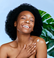 Image showing Skincare, cream and woman with monstera plant for beauty, cosmetics and natural product, moisturizer or collagen. African person or model with lotion, plants and dermatology on studio blue background