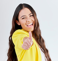 Image showing Portrait, support and woman with thumbs up, excited or achievement on a white studio background. Face, female person and like with hand gesture, agreement or promotion with a sign, feedback or review