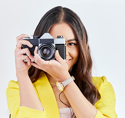 Image showing Creative, portrait and a woman with a camera for a photo, memory or career in photography. Happy, paparazzi and a young girl or photographer taking a picture isolated on a white background in studio