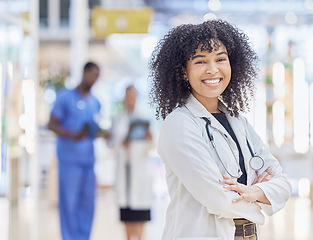 Image showing Doctor, portrait and woman smile with arms crossed in hospital for healthcare, wellness and pride for career. Face, confidence and African medical professional, surgeon or happy employee in clinic.