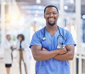 Image showing Portrait, nurse and black man with arms crossed, healthcare and happy in hospital. African doctor, face and confident surgeon, medical professional or worker with pride for career, job and wellness.