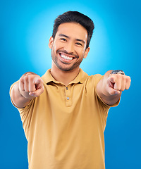 Image showing Portrait, man and pointing to you in studio, blue background and hands for choice of decision, winner and volunteering opportunity. Smile, asian male model and finger emoji for recruitment of hiring