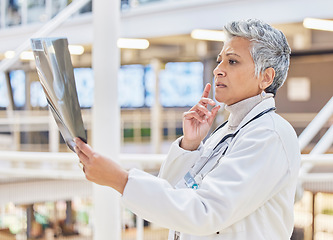 Image showing Xray, doctor or mature woman thinking of solution in hospital for healthcare research, results or analysis. MRI, exam check or senior medical worker planning for anatomy review or injury assessment