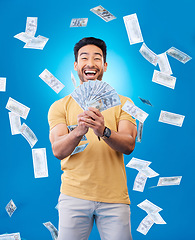 Image showing Happy, portrait of a man with money fan and in a blue background for investment. Rich or cash, stock market or budget and male person with financial freedom against a studio backdrop for winner prize