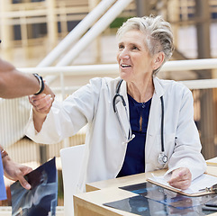 Image showing Senior doctor, shaking hands and introduction, thank you and congratulations with gesture and health. Welcome, communication and support in medicine, female medical professional and handshake