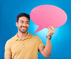 Image showing Happy, speech bubble and thinking Asian man for communication, feedback or chat. Excited, idea and a person with a board for conversation isolated on a blue background in a studio with space