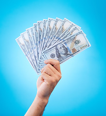 Image showing Money, studio hands and person show dollar bills, reward or bonus cash salary, profit or wealth. Financial pay increase, winning and rich winner with income, finance revenue or win on blue background