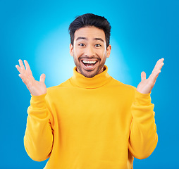 Image showing Wow, excited man and surprise portrait in studio with Asian model with teeth and joy. Blue background, male person and casual fashion with handsome and friendly guy with modern style and happy